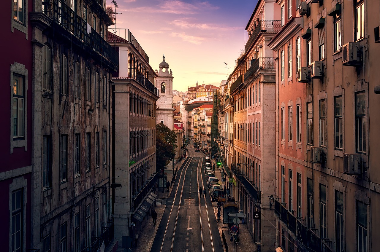 A charming European street with historic buildings and evening lights.