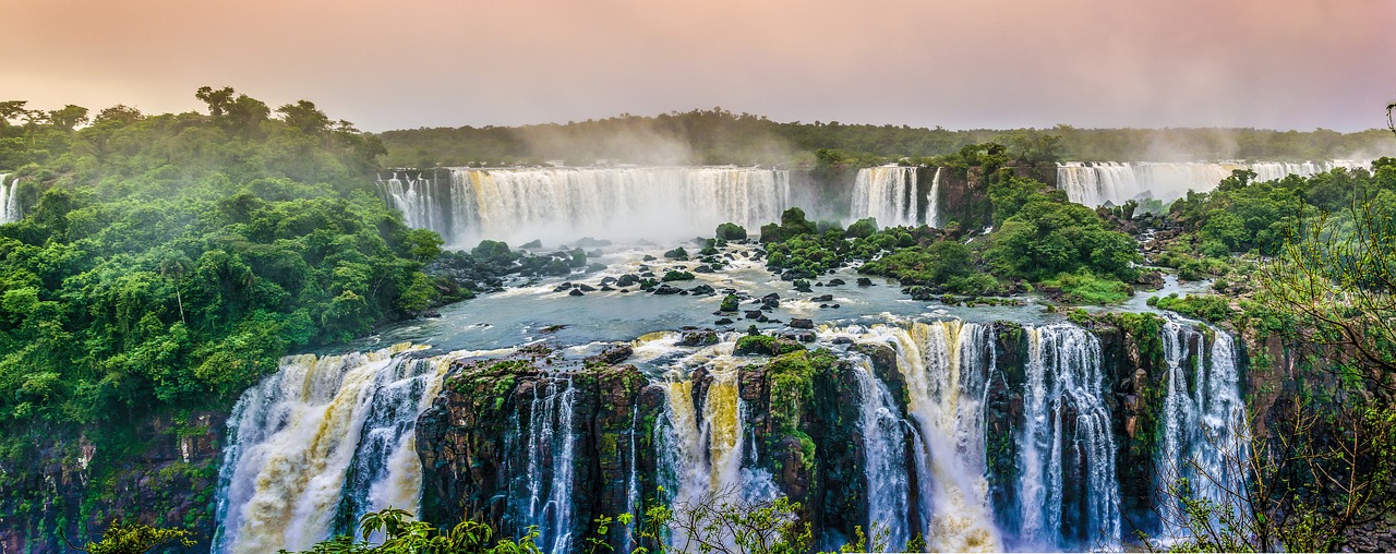 A serene waterfall cascading into a green tropical swimming hole