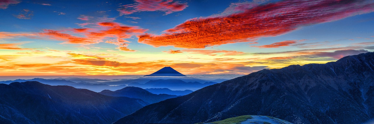 The smoking crater of Mount Bromo surrounded by a sea of sand and morning mist.