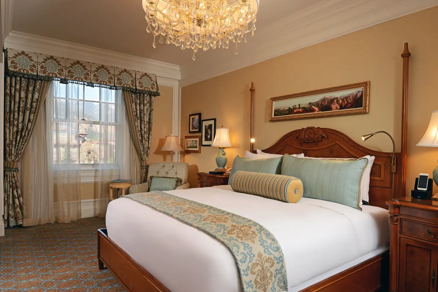 A luxury hotel suite at The Broadmoor with a chandelier and refined furnishings.