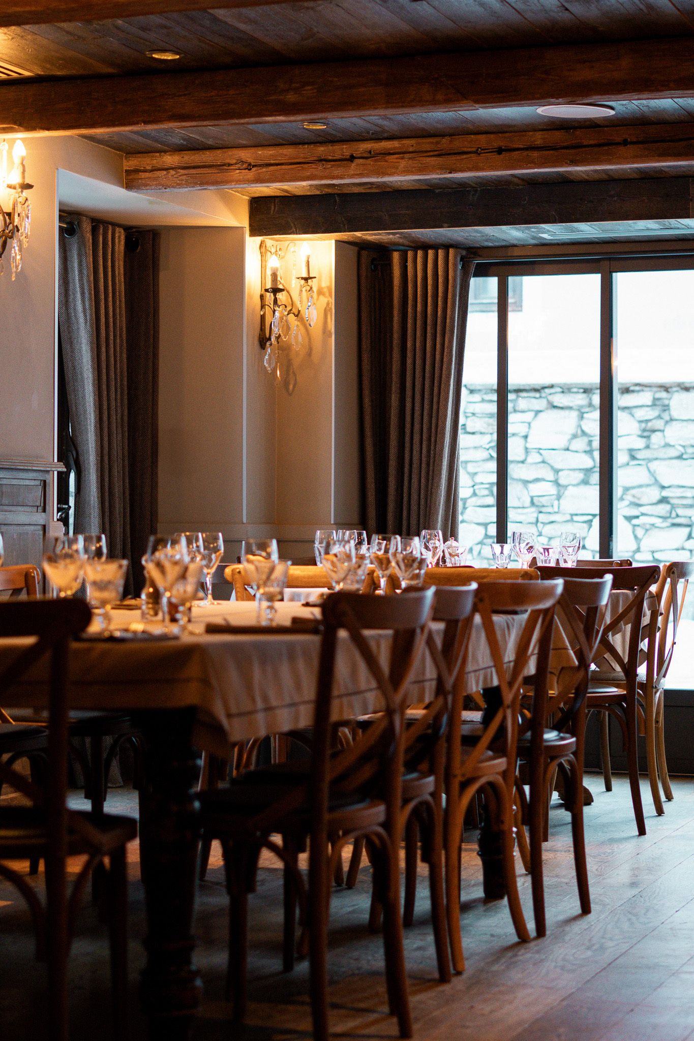 An elegant dining room with wooden furniture and a view of classic architecture through the window.