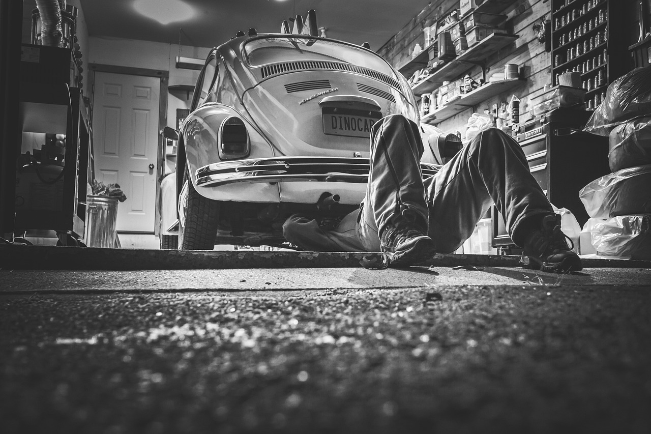 A close-up of a person checking the tire pressure and engine fluid levels before a trip.
