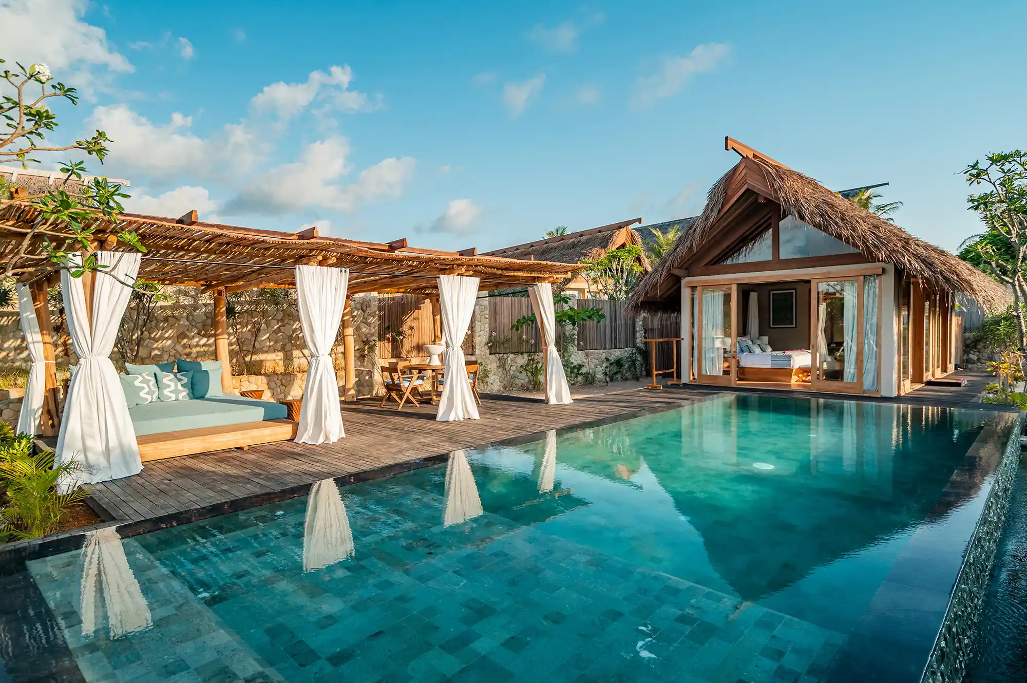 Luxury villa on Rote Island with a thatched roof, private pool, and views of the tropical surroundings.