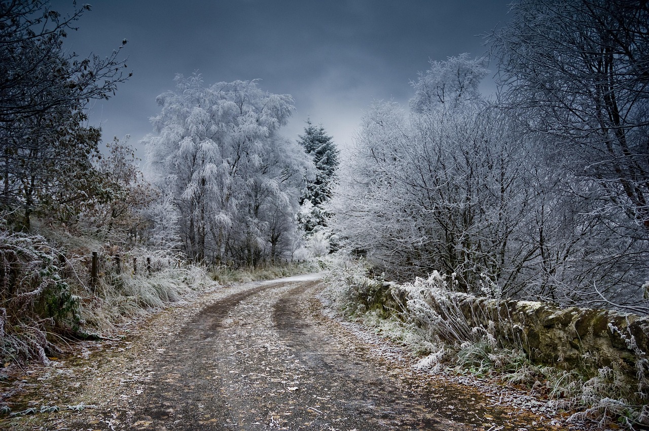Moody winter landscape of the Scottish Highlands with snow-capped peaks and mist