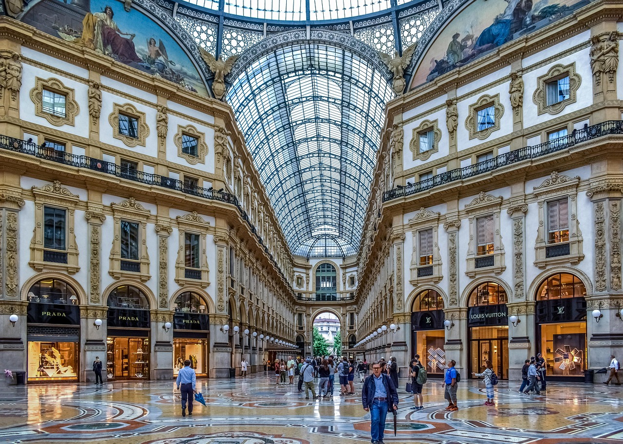 The ornate glass dome and luxury storefronts of the Galleria Vittorio Emanuele II in Milan.