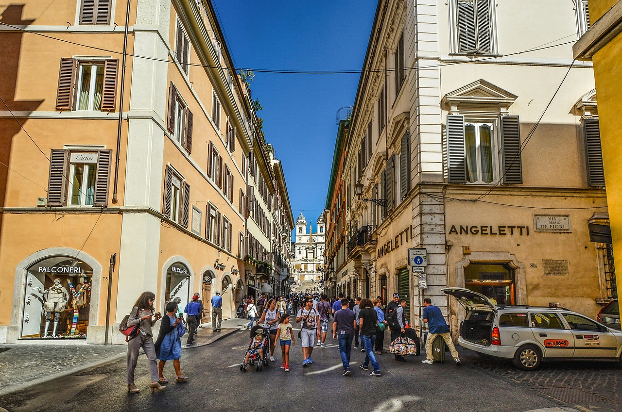 A charming narrow alleyway in Rome with laundry hanging and local restaurant signs.