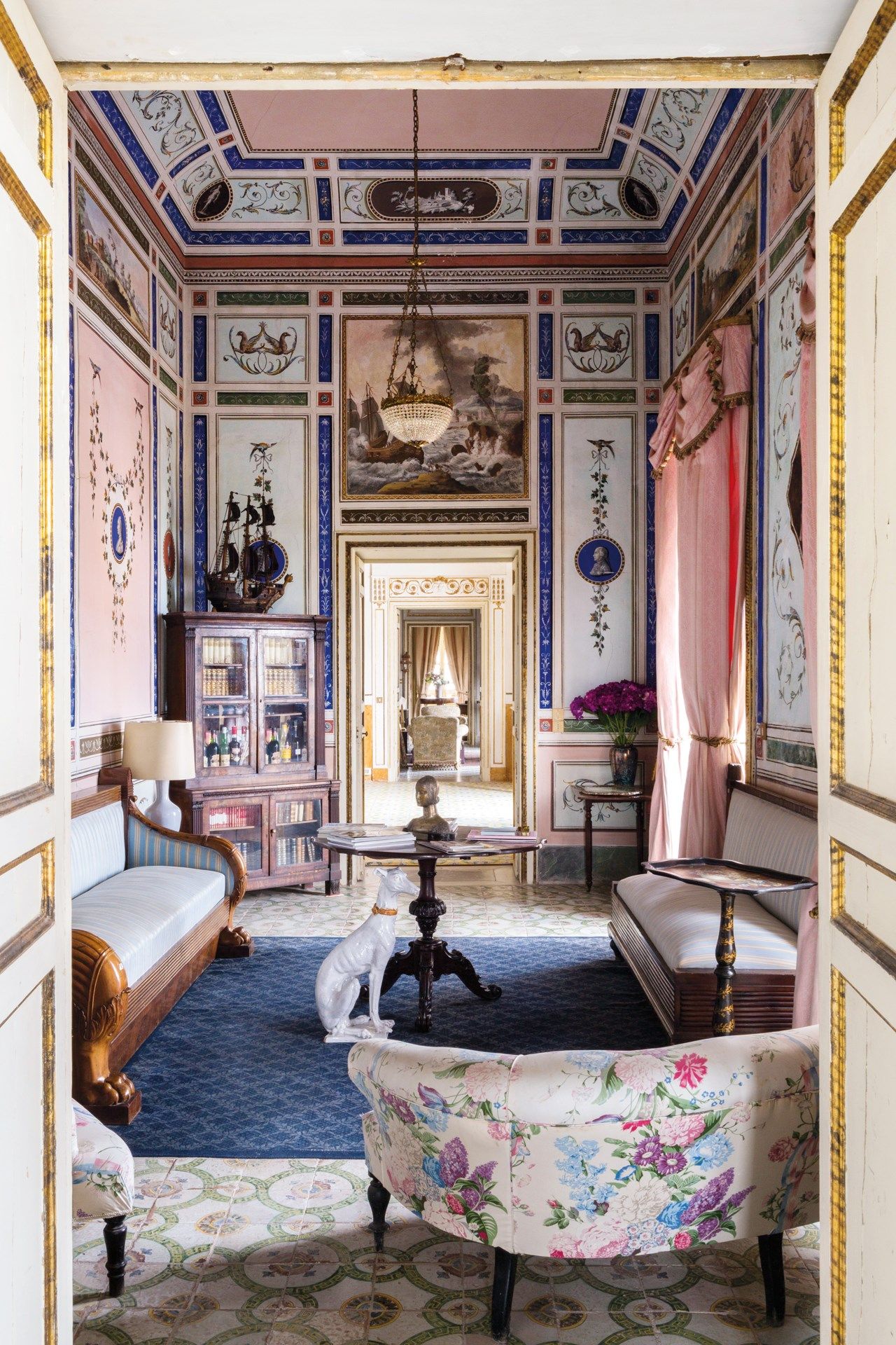 Luxurious Neoclassical reception room inside Villa Valguarnera with period furniture.