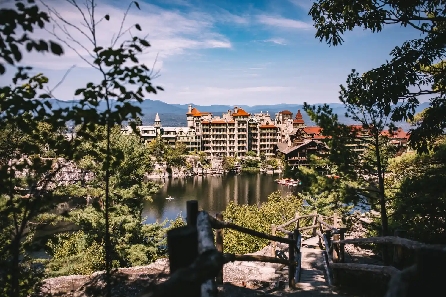 Mohonk Mountain House situated by a lake and surrounded by dense forest.