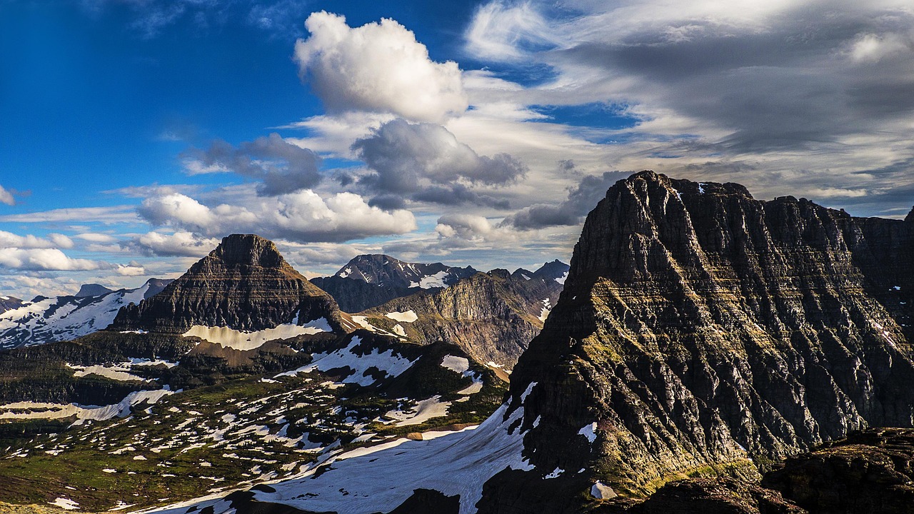 The sheer granite face of Longs Peak towering against a blue sky