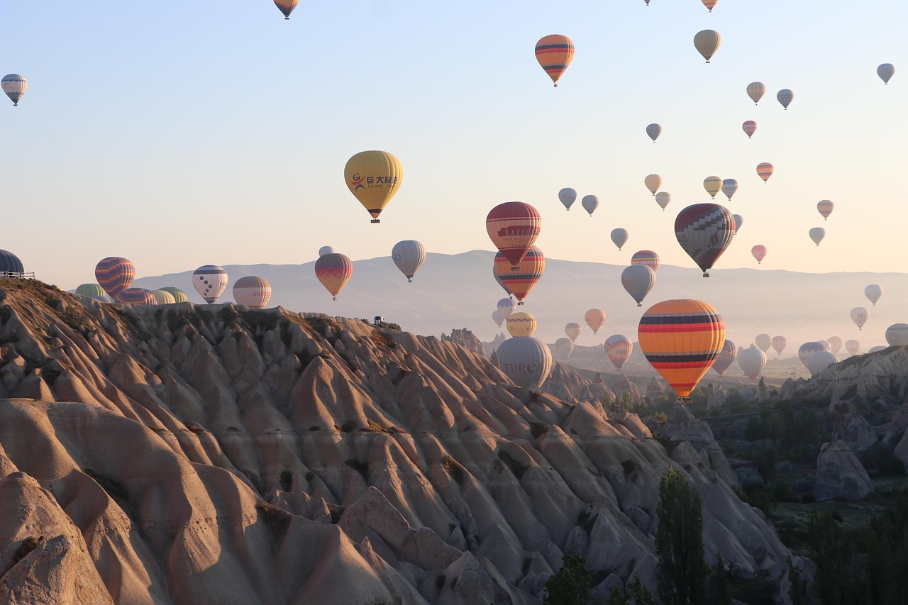 Dozens of hot air balloons flying over the fairy chimneys of Cappadocia