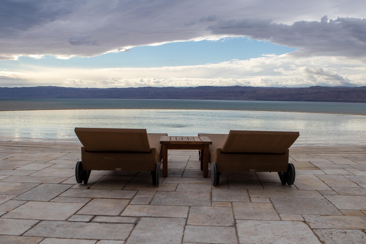 A luxury infinity pool overlooking the blue ocean at a high-end Caribbean resort.