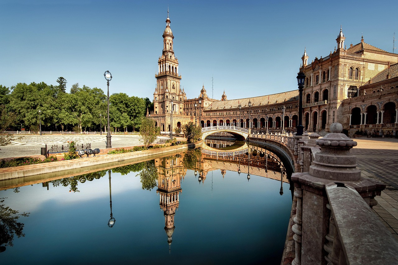 A traditional yet luxury Andalusian patio with orange trees and intricate tile work.