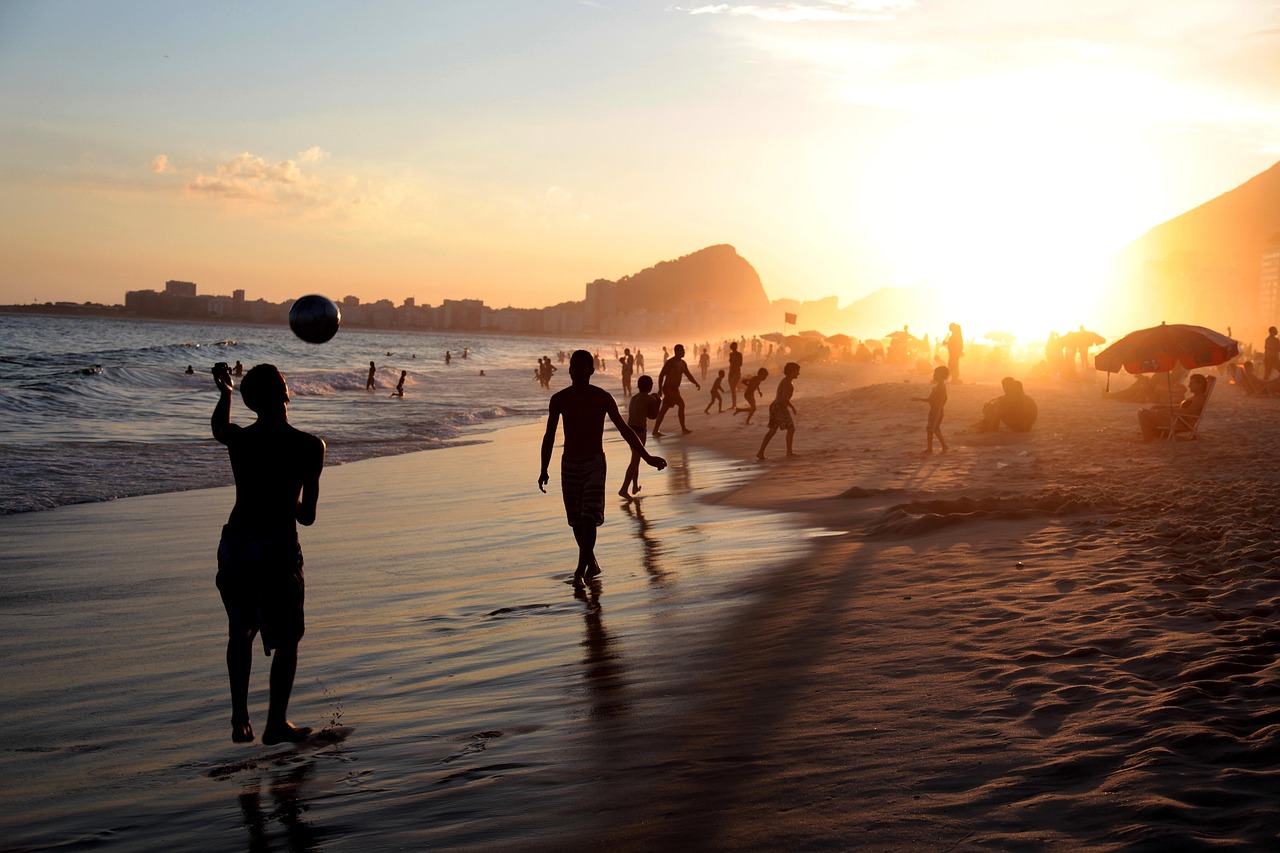 A massive crowd gathered on Copacabana Beach during a sunset concert.