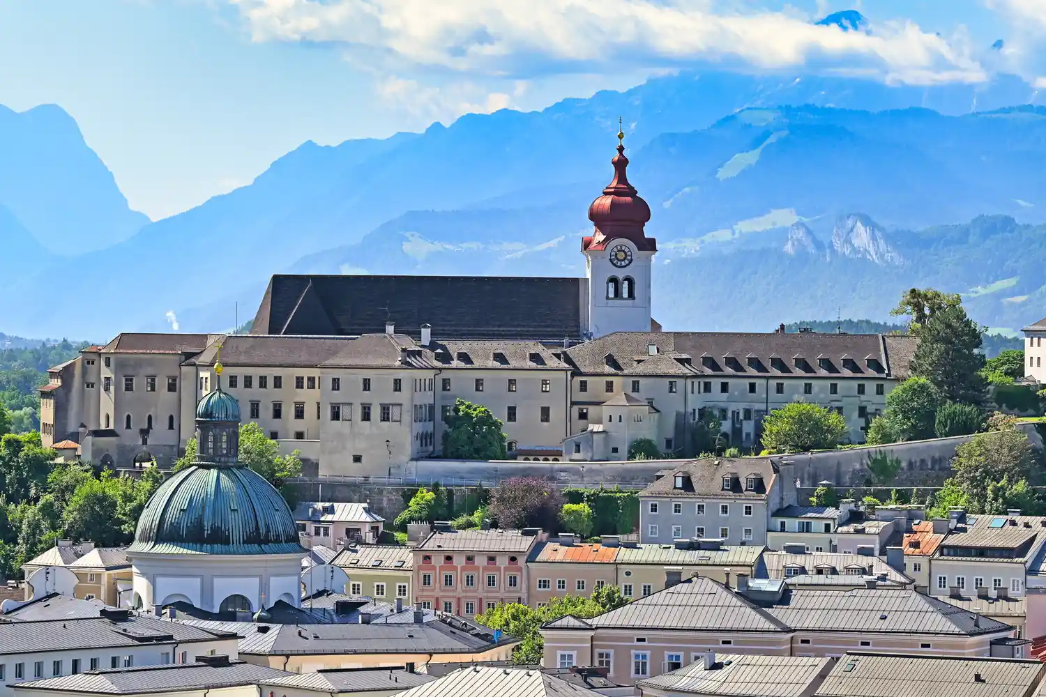 The historic Nonnberg Abbey with a view of the surrounding mountains.