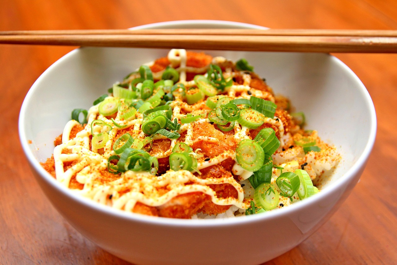 A steaming bowl of Japanese ramen on a wooden table