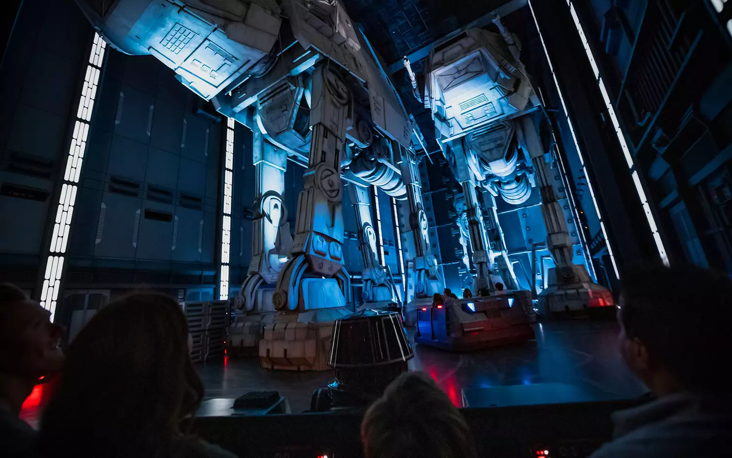 A line of First Order Stormtroopers standing inside a massive Star Destroyer hangar.