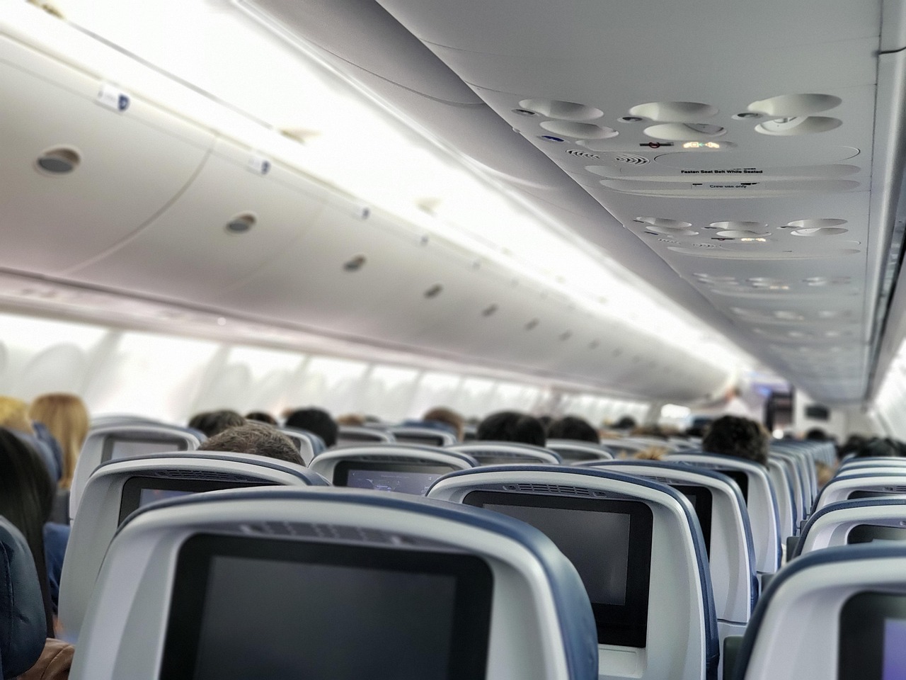 Modern business class cabin with lie-flat seats and premium amenities.