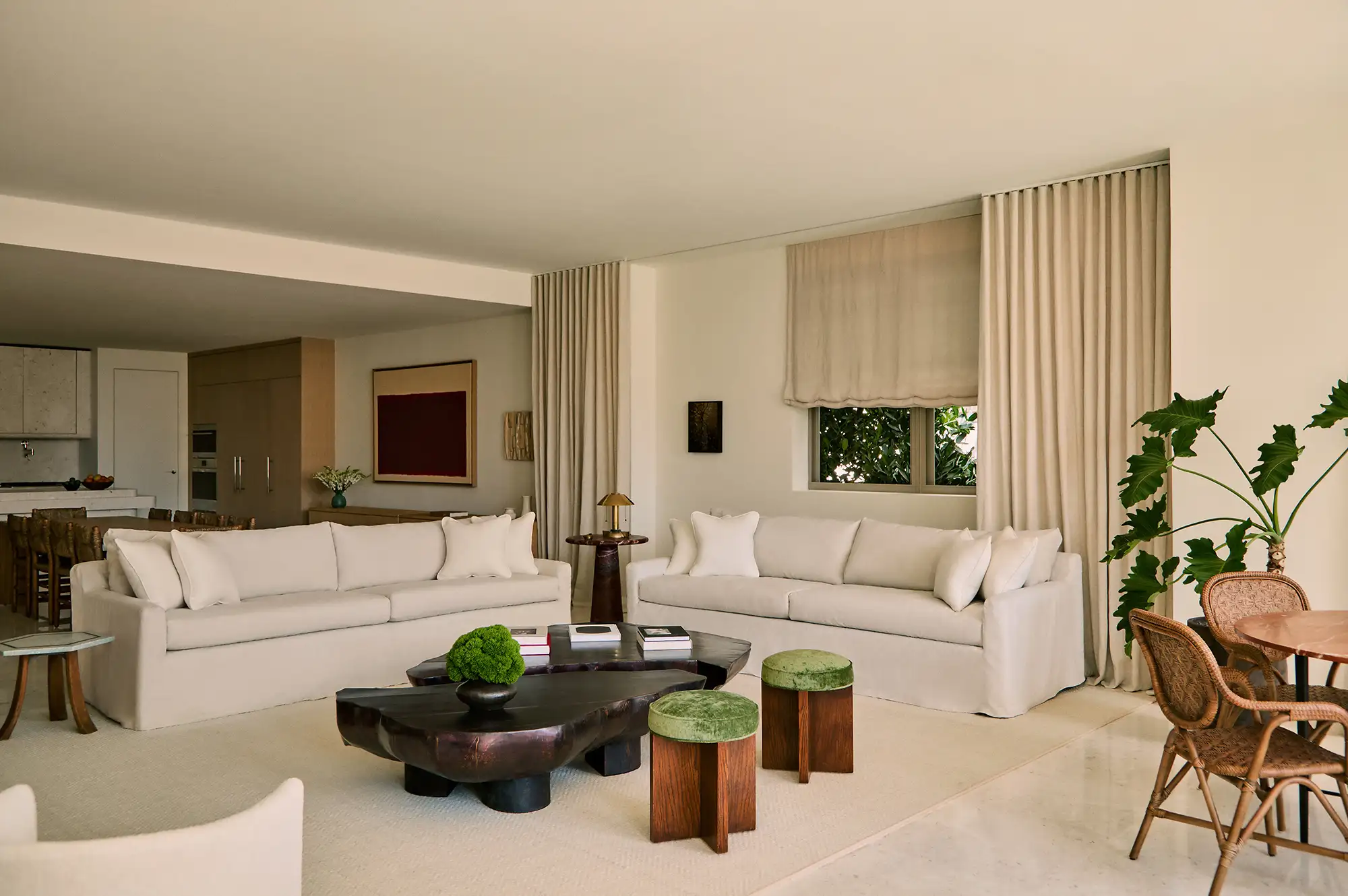 A luxurious living room with neutral tones, designer furniture, and artistic decor elements.