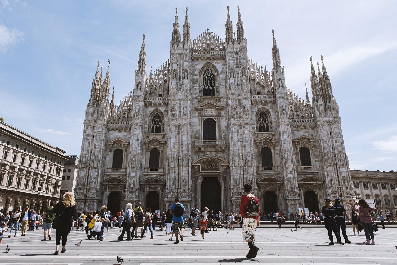 The iconic Duomo di Milano in winter with pigeons in the square.