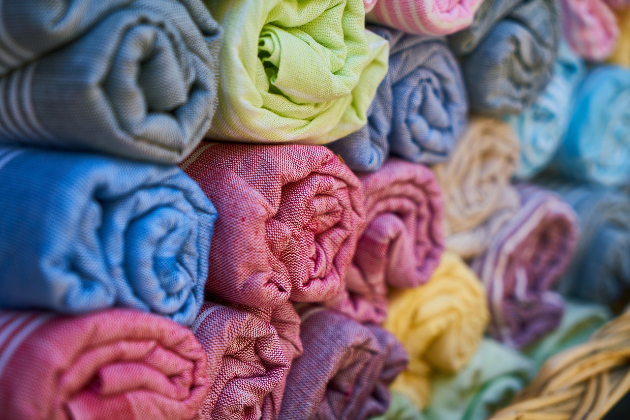 A macro close-up of soft cotton loops and a smooth microfiber weave side by side.