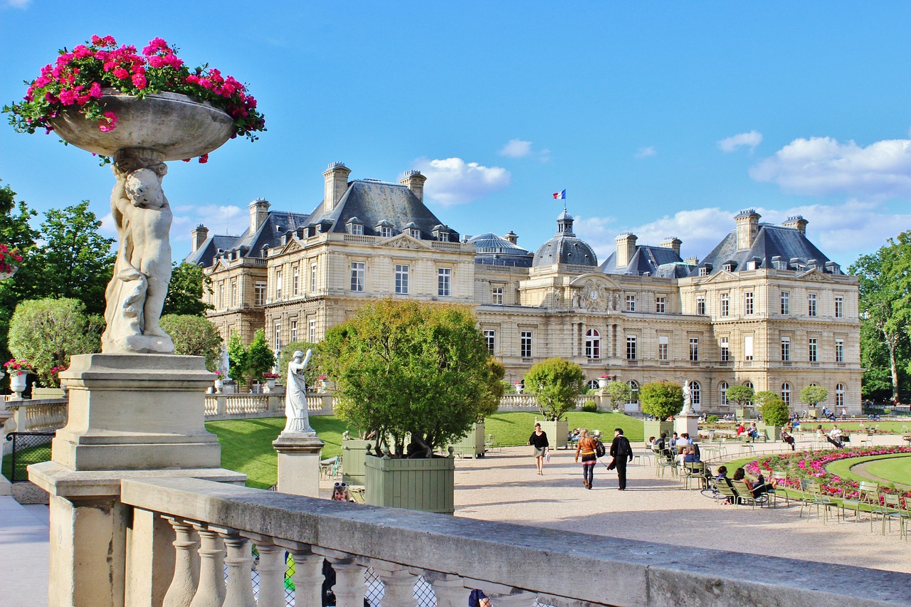 Children playing with wooden toy boats at the Luxembourg Gardens pond.