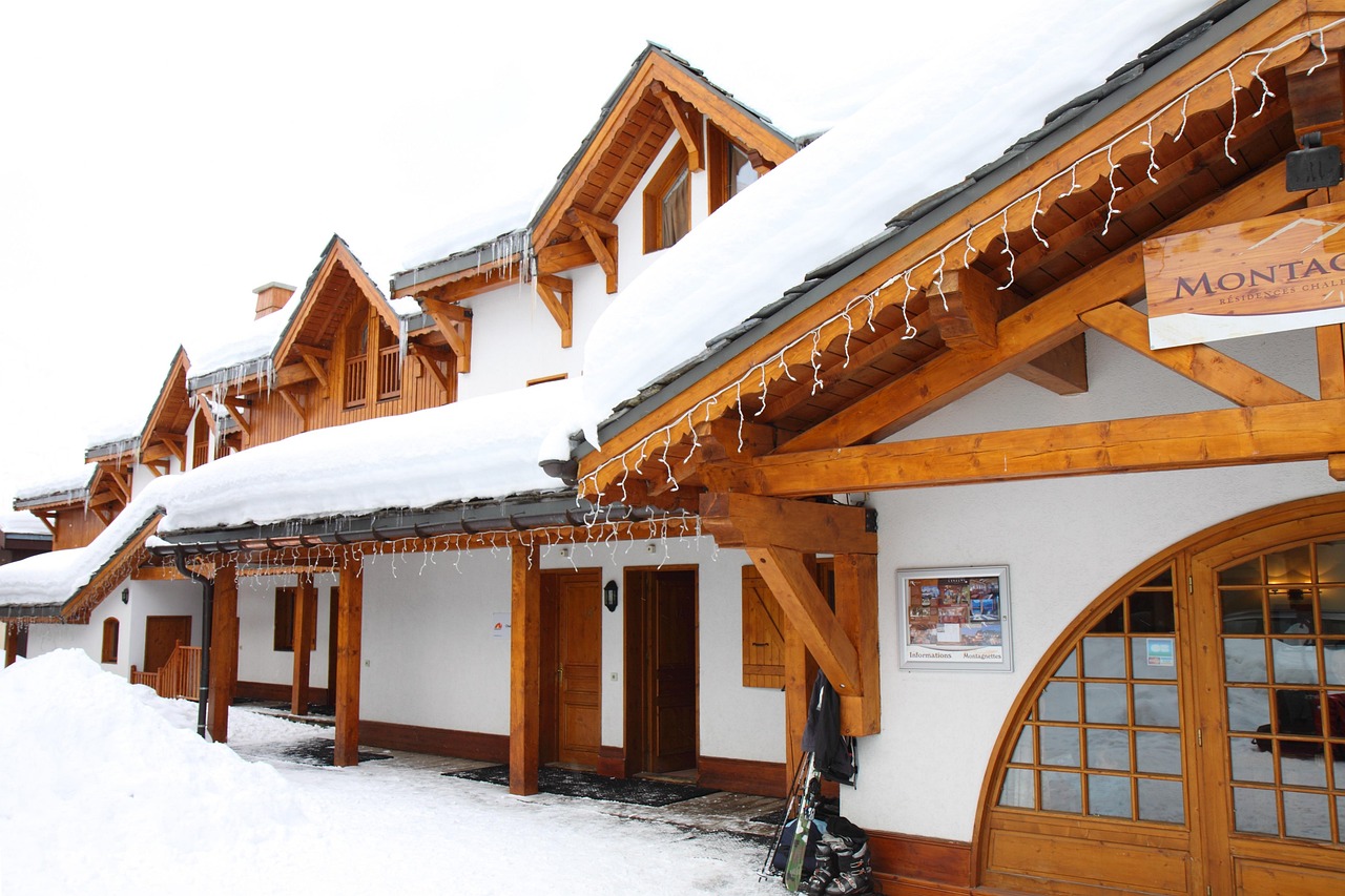 A luxury alpine chalet with snow-covered mountains in the background