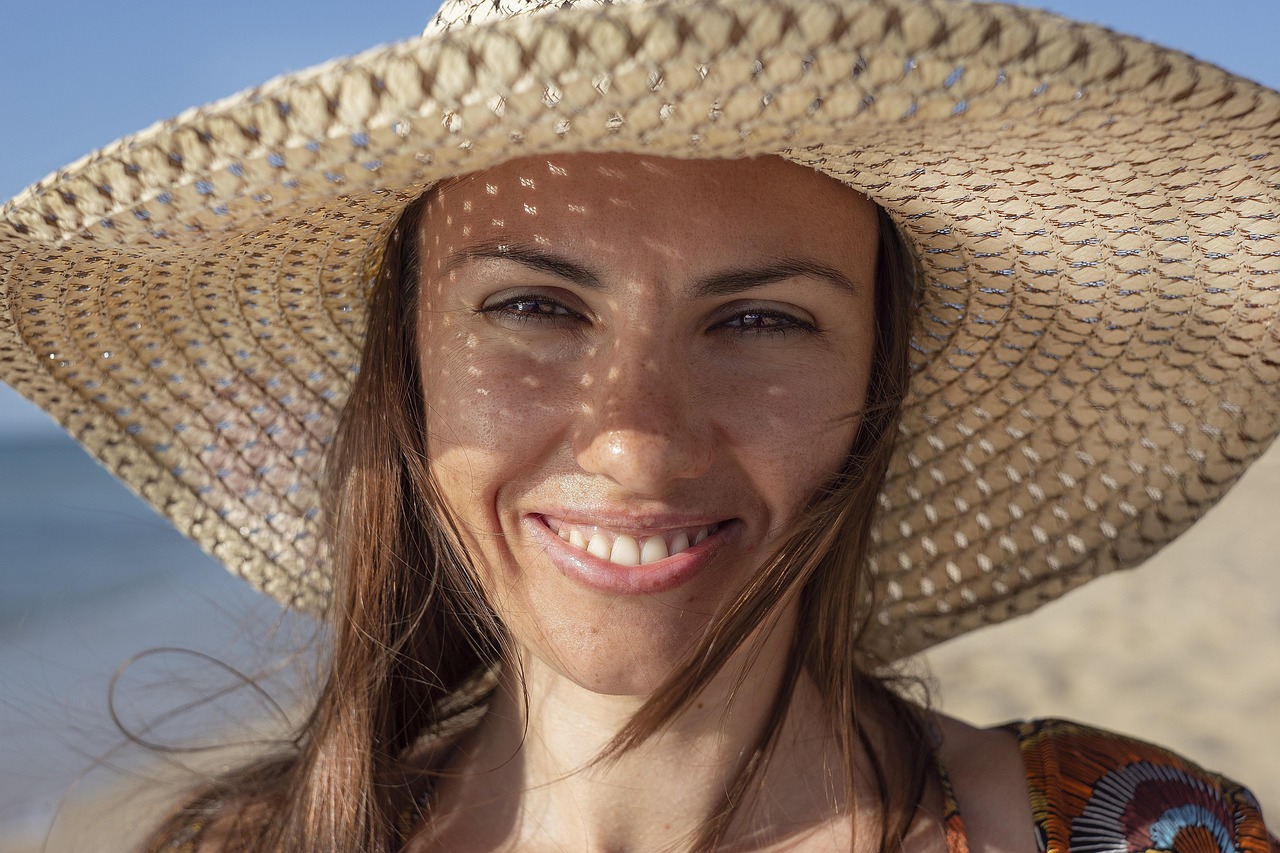 Close up of a high-quality wide-brim straw hat resting on a beach chair.