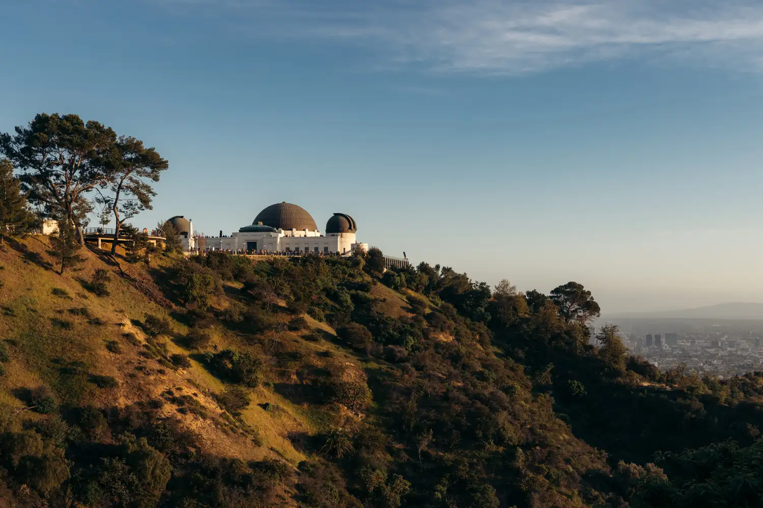 The Griffith Observatory in Los Angeles overlooking the city under a clear sky.