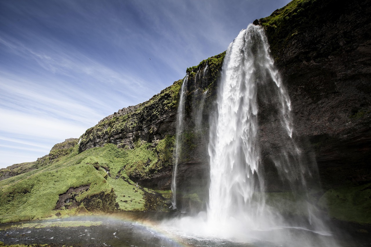 A powerful Icelandic waterfall with a rainbow appearing in the mist.