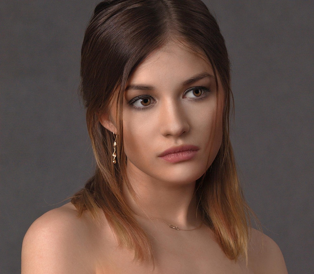 A woman applying serum to her radiant face, symbolizing the 'Cruising Altitude Glow'.