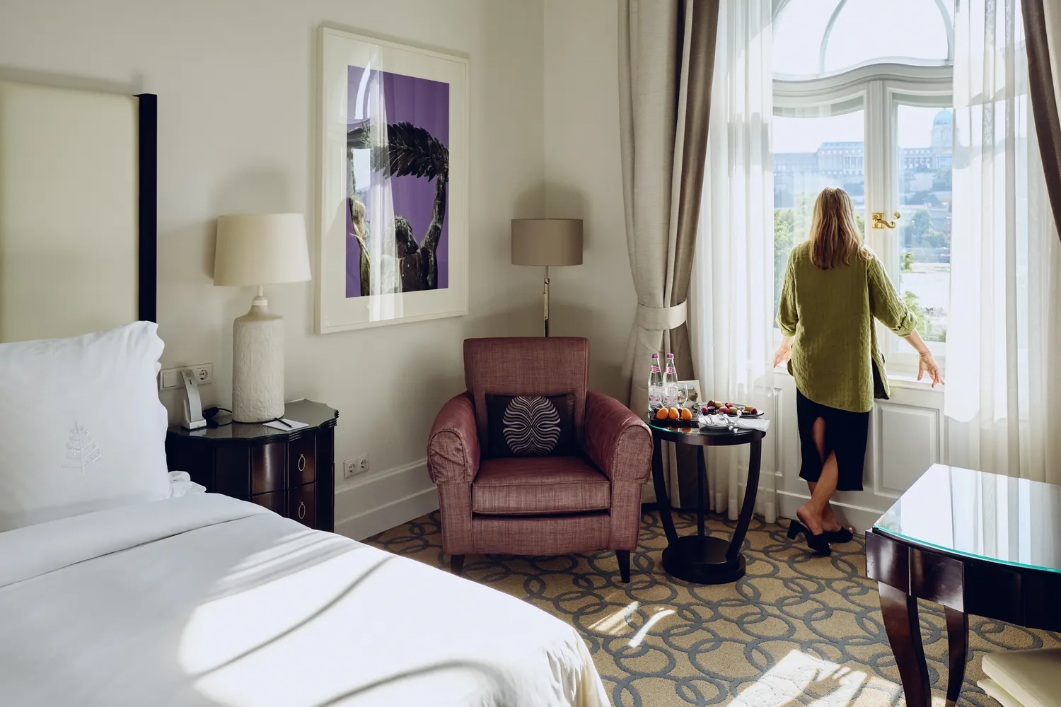 A luxury hotel room at the Four Seasons Gresham Palace with a view of the Budapest skyline.