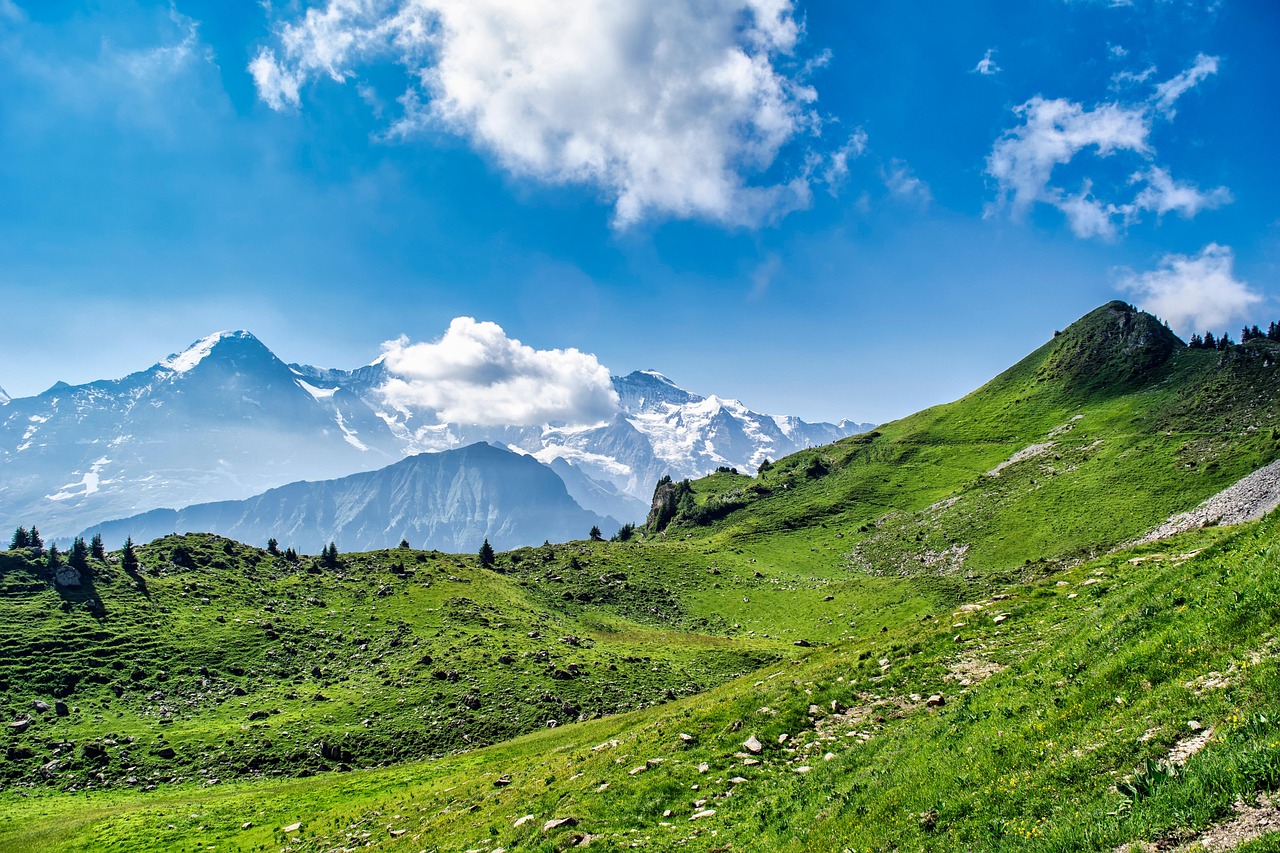 A vast green valley surrounded by volcanic mountain ridges.