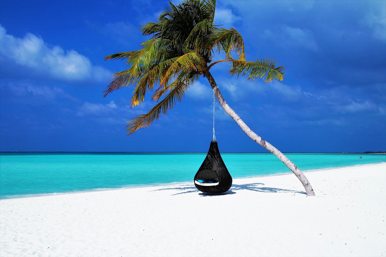 Hammocks swinging over shallow lagoon waters in Jericoacoara, Brazil.